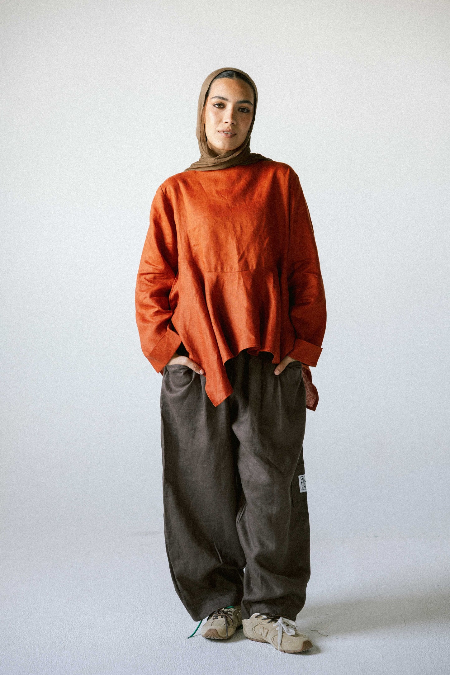 Ruffeled linen top in burnt-orange