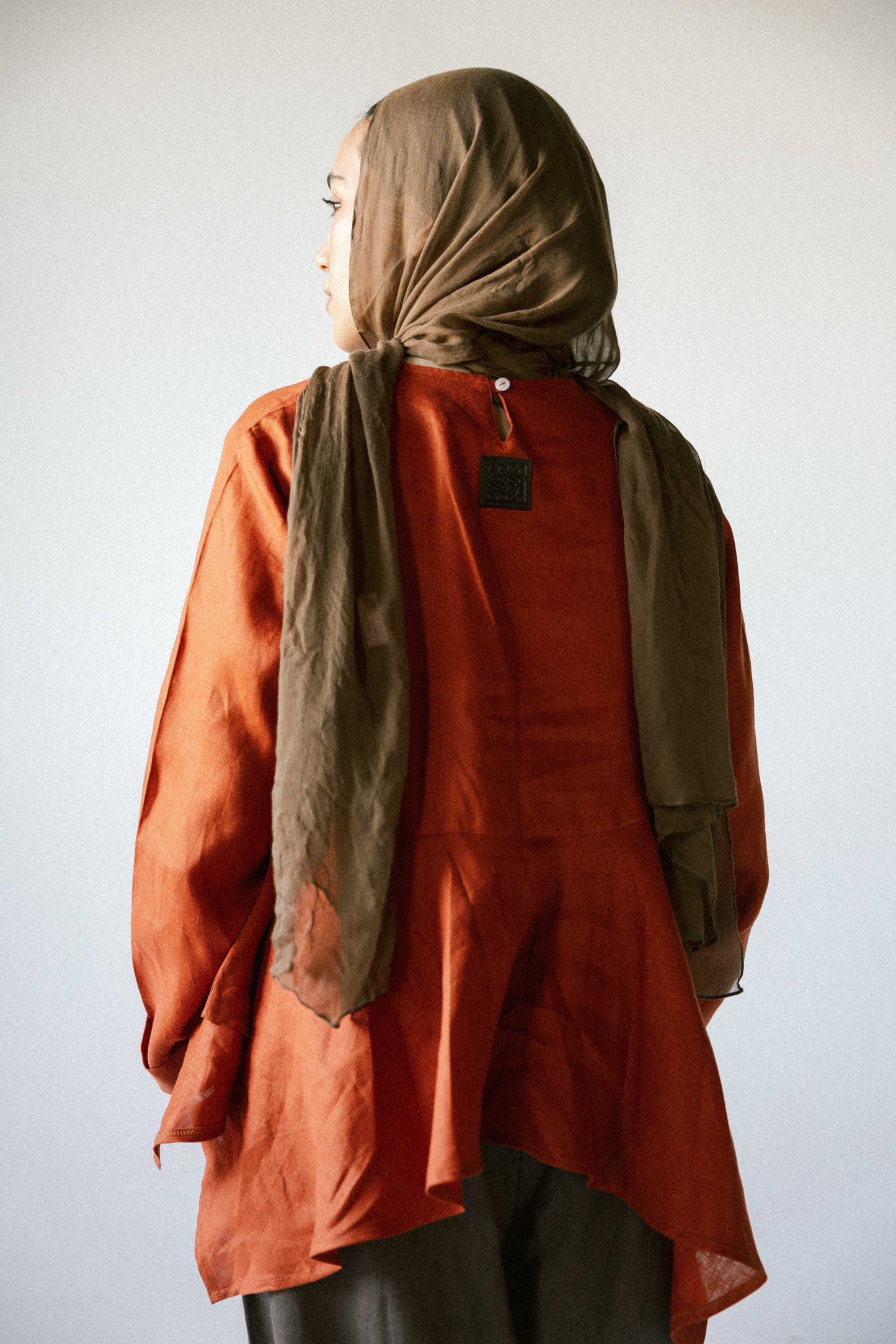 Ruffeled linen top in burnt-orange